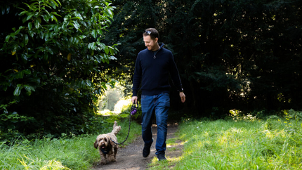 Laurie and Archie walking in a woodland