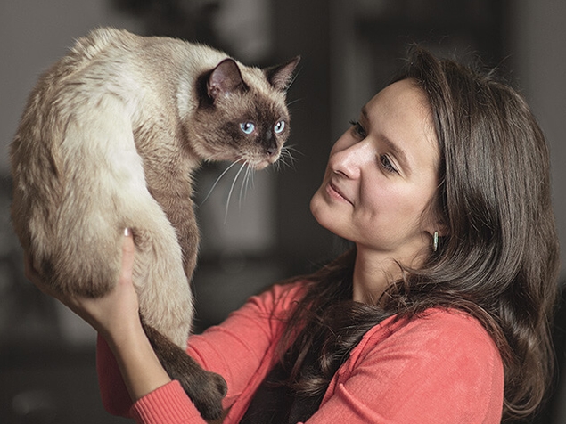 Woman holding up Cat