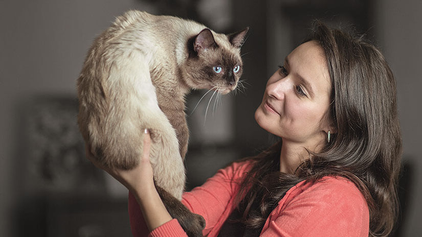 Woman holding up Cat