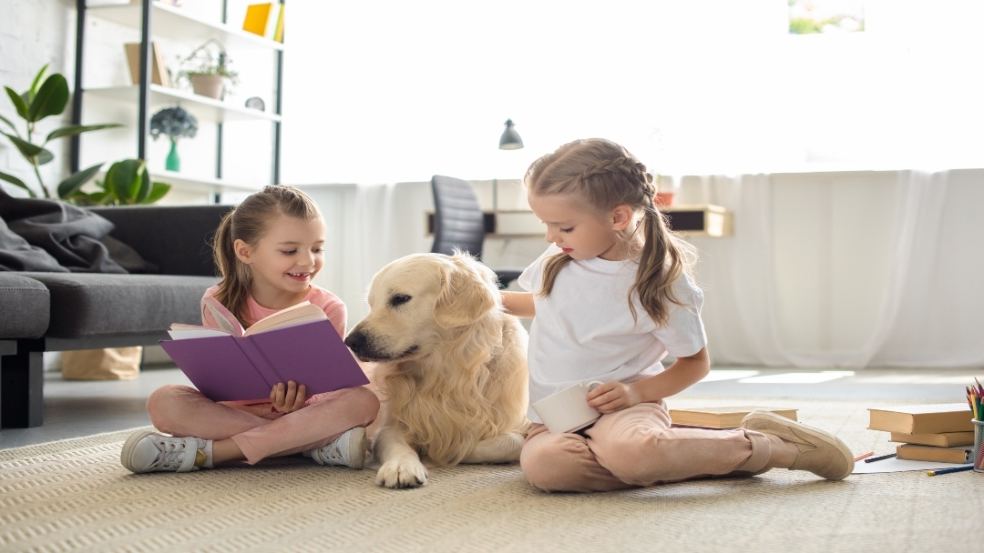 children on the floor with dog