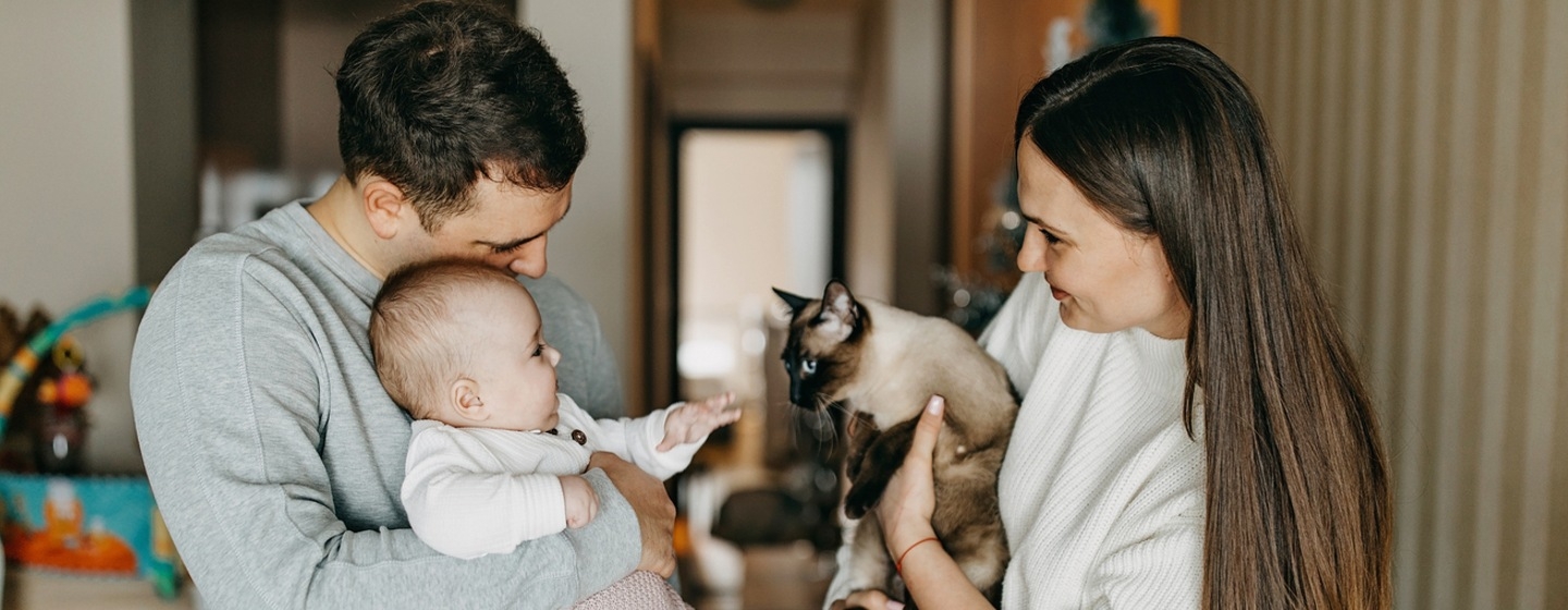 family holding baby and cat
