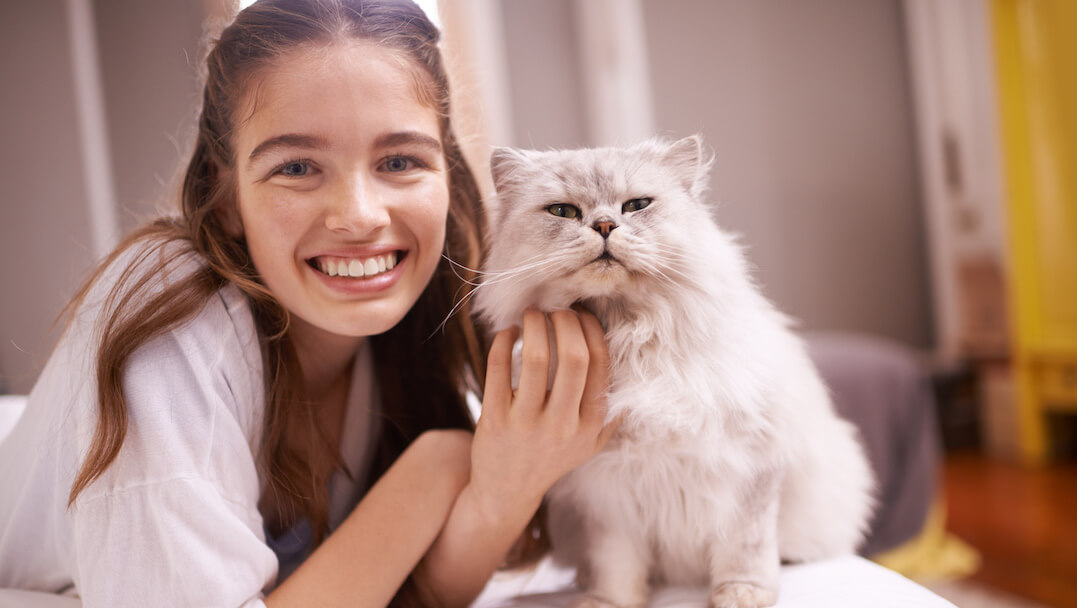 Woman smiling with a cat