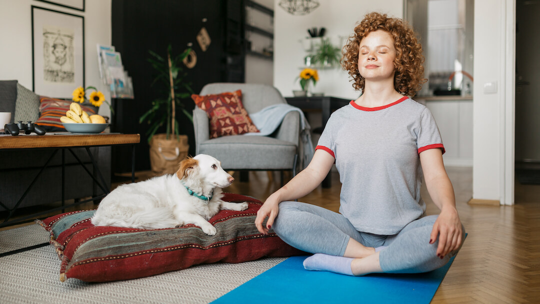 Woman and dog meditating