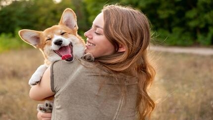 woman holding corgi