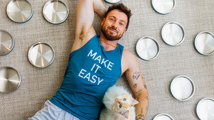 Sam Thompson lying on the floor with his cat