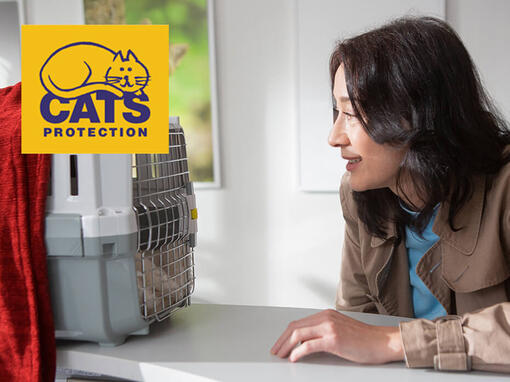 woman looking into cat carrier