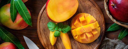 Ripe mango on a wooden board