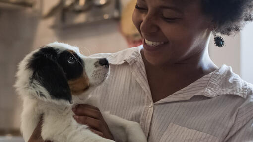 woman sitting in the kitchen with her dog