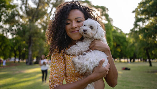 woman with a white dog outside