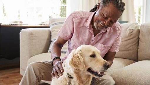 man with golden retriever