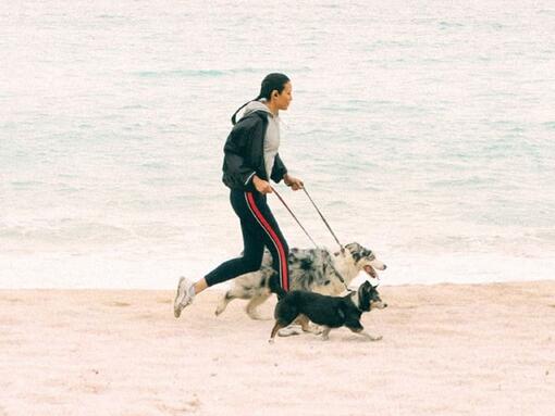 Girl running with dogs