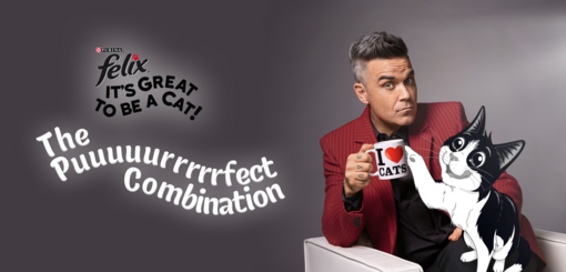 Felix and Robbie together, Robbie holding I love cats mug.
