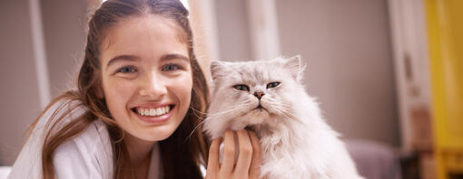 Woman smiling with a cat - hero