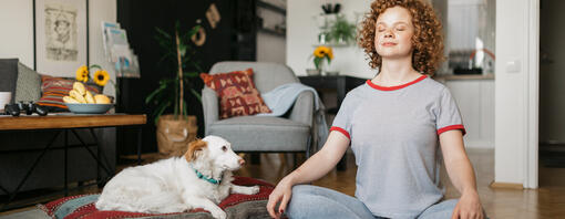 Woman and dog meditating - hero