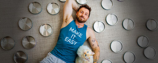 Sam Thompson lying on the floor with his cat