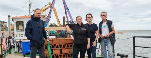 George, Jo, Claire and Allie aboard the boat with the oyster crates