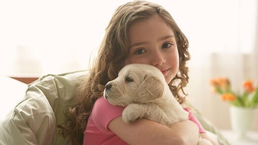 girl holding a puppy